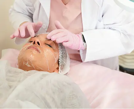 HydroGlow facial treatment with gloved hands at MIRRA BELLA